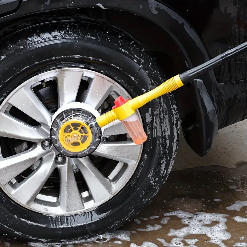 Car washing brush with long handle reaching the roof of a vehicle