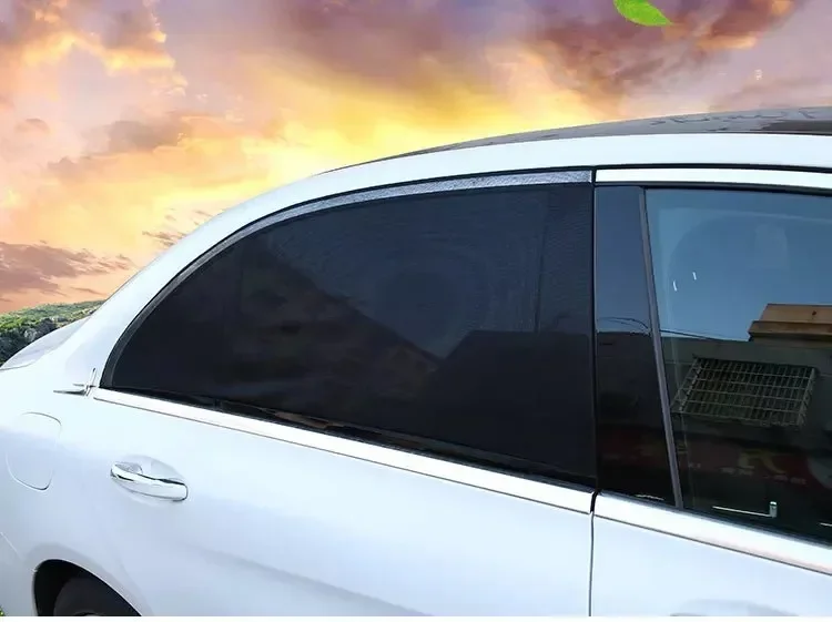 Rear side window covered by the mesh sun shade protecting a baby